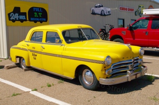A taxi outside, though probably just a faux taxi to make a dowdy old Dodge more interesting. Hey, it works.